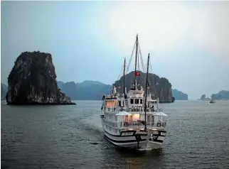  ??  ?? A tourist boat plies its trade on Ha Long Bay.