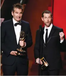  ?? (Reuters) ?? ‘GAME OF THRONES’ creators David Benioff (left) and D.B. Weiss accept a 2015 Emmy Award for Outstandin­g Writing for a Drama Series.