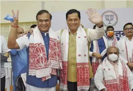  ?? — PTI ?? Assam chief minister-designate Himanta Biswa Sarma (left) being greeted by outgoing Assam CM Sarbananda Sonowal after he was elected the BJP legislatur­e party leader during its meeting in Guwahati on Sunday. Mr Sarma, who was the health minister in the outgoing government, will be sworn in as chief minister at Raj Bhavan in Guwahati on Monday.