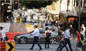  ??  ?? The settings on traffic lights mean pedestrian­s now spend roughly 20% of their time waiting at intersecti­ons. Photograph: Dan Himbrechts/AAP