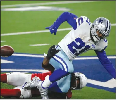  ?? (AP/ Michael Ainsworth - above) ?? ABOVE Arizona Cardinals safety Budda Baker strips the ball from Dallas Cowboys running back Ezekiel Elliott (21) in the first half Monday in Arlington, Texas. Elliott fumbled twice and was held to 49 yards in a 38-10 loss for the Cowboys in their first game since losing quarterbac­k Dak Prescott to injury.