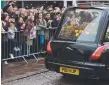  ??  ?? Well-wishers pay their respects as Hawking’s hearse drives past.