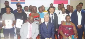  ?? (Pic: Sibusiso Zwane) ?? Some of the 32 candidates who passed the welding tests and were awarded certificat­es yesterday in a group photo with the guests; Minister of Education and Training Owen Nxumalo, Ching-Lin Tsuei, the Minister in the Embassy of the Republic of China (Taiwan) in Eswatini and Minister of Labour and Social Security Phila Buthelezi.