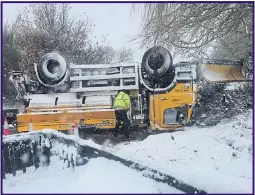  ??  ?? An overturned gritter truck on an icy road in Tamworth, Staffs