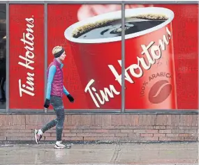  ?? COLE BURSTON THE CANADIAN PRESS FILE PHOTO ?? Tim Hortons’ inner-city coffee shops, often near office towers and in food courts, were hit hardest by the work-fromhome trend.