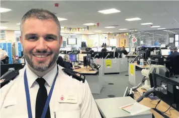  ??  ?? Superinten­dent Gareth Morris and, below, a call handler at work in the Triservice Emergency Centre