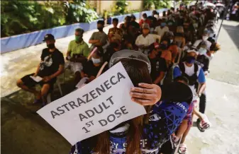  ?? Aaron Favila / Associated Press ?? Residents wait for COVID-19 vaccinatio­ns in Quezon city in the Philippine­s. The World Health Organizati­on is seeking an internatio­nal pact to help prevent and fight future pandemics.