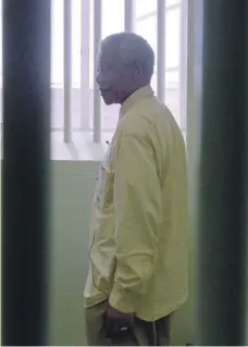  ?? Corbis via Getty Images ?? Mandela revisits the Robben Island prison cell where he was jailed for more than two decades