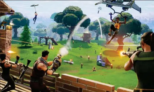  ??  ?? Kill or be killed: Fortnite is set on a dystopian island where players battle with grenade launchers, crossbows and rifles