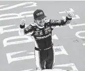  ?? Logan Riely / Getty Images ?? Ryan Blaney, driver of the No. 12 Ford, celebrates his win at Michigan Internatio­nal Speedway on Sunday.