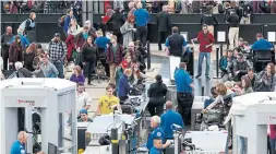  ?? DAVID ZALUBOWSKI THE ASSOCIATED PRESS ?? Travellers wait to pass security checks in Denver Internatio­nal Airport.