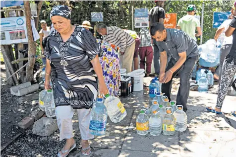  ??  ?? Scenes of people collecting water from boreholes, in this case in Newlands, may soon be common place as drought-hit Cape Town gets closer to turning off the water supply