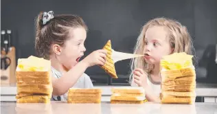  ?? Picture: David Caird ?? Charlotte and Matisse, 5, enjoy a cheese toastie.