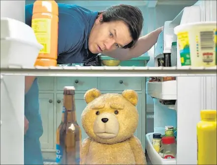  ?? Universal Pictures ?? JOHN ( MARK WAHLBERG)
and Ted ( voiced by Seth MacFarlane) keep their friendship going through life changes in “Ted 2.”