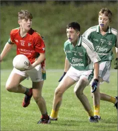  ??  ?? Danny Breen of the Starlights gets his pass away as Naomh Eanna’s Darragh Fitzpatric­k closes in.