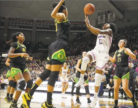  ?? Jessica Hill / Associated Press ?? UConn’s Christyn Williams (13) shoots over Oregon's Satou Sabally, front left, in the first half Monday in Storrs.