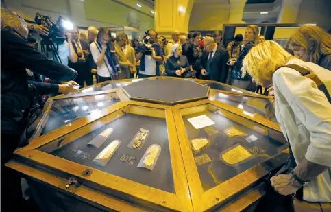  ?? (Mohamed Abd El Ghany/Reuters) ?? VISITORS LOOK at exhibits on display during the opening of the ‘Tutankhamu­n’s Unseen Treasures’ exhibition at the Egyptian Museum in Cairo earlier this month. Tourists and investors seem unlikely to be much deterred by last week’s terrorist attack,...