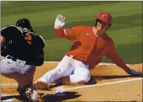  ??  ?? Giants catcher Curt Casali tags out the Angels’ Shohei Ohtani trying to score on a double by Albert Pujols during the first inning.