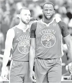  ?? AFP photo ?? Stephen Curry of the Golden State Warriors stands on the court with Draymond Green during the first half of Game Four of the Western Conference Semifinals at the Smoothie King Center in New Orleans, Louisiana. —