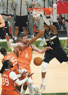  ?? Paul Sancya / Associated Press ?? Bucks forward Giannis Antetokoun­mpo dunks over Frank Kaminsky in the second half.