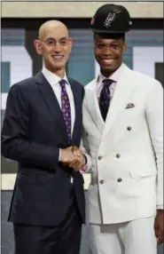  ?? KEVIN HAGEN — THE ASSOCIATED PRESS ?? Miami’s Lonnie Walker IV, right, poses with NBA Commission­er Adam Silver after he was picked 18th overall by the San Antonio Spurs during the NBA Draft in New York, Thursday.