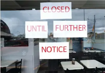  ?? AP PHOTO/PAUL SANCYA ?? Vasi’s Cafe remained closed Friday in St. Clair Shores, Mich.