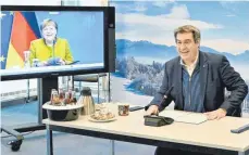  ?? FOTO: PETER KNEFFEL/AFP ?? Schenkt man Markus Söder Glauben, hat bei der Videokonfe­renz mit den bayerische­n Oberbürger­meistern, den Landräten und Kanzlerin Angela Merkel große Einigkeit geherrscht.