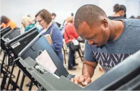  ?? JOHN MINCHILLO/AP ?? Elijah Ransom of Columbus, Ohio, voted early in the 2016 election. The state’s process of cleaning up voter rolls is the nation’s strictest.