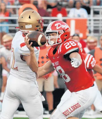  ?? ANDY LAVALLEY/POST-TRIBUNE ?? Crown Point’s Liam Begley, right, prepares to hit Andrean quarterbac­k Scott Ballentine on Aug. 27.