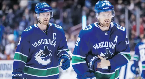  ?? DARRYL DYCK/THE CANADIAN PRESS FILES ?? Henrik Sedin, left, and his twin brother Daniel have been the faces of the Vancouver Canucks since 2000, and will retire together this year.