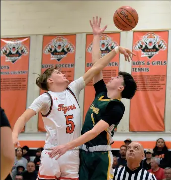  ?? ARCENIO J. TRUJILLO/Taos News ?? Starting center Lionel Salazar competed and won the initial jump ball during the district title game at Otero Gymnasium Mar. 2. Salazar, who is slated to graduate this spring, scored 7 points in his last home game as a Taos Tiger.