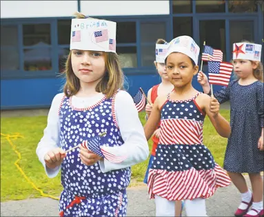  ?? Cassandra Day / Hearst Connecticu­t Media ?? The entire Edna C. Stevens Elementary School student body, 485 pre-kindergart­en through second-grade children, sang songs, read poems they had written, and took part in other festivitie­s Wednesday morning for the annual Flag Day observance in Cromwell.