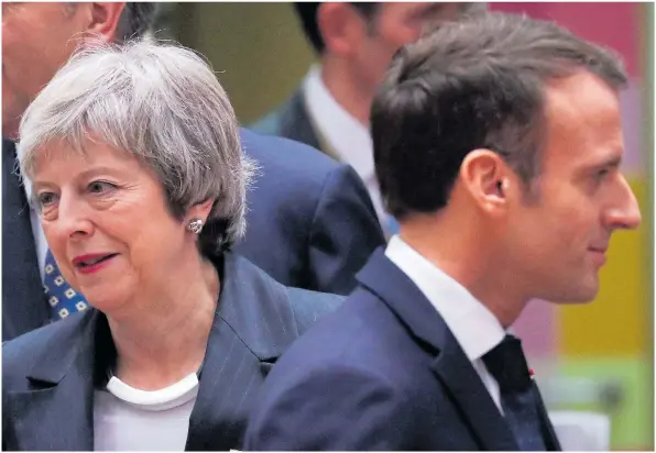  ??  ?? The Prime Minister was given the cold shoulder by French president Emmanuel Macron at the EU summit in Brussels yesterday