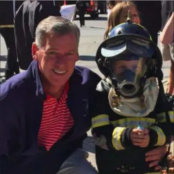  ?? SUBMITTED PHOTO ?? Tom McGarrigle poses for a photo with a future firefighte­r.