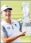  ?? ?? K.H. Lee, of South Korea, holds up the AT&T Byron Nelson trophy after winning the golf tournament in McKinney, Texas. (AP)