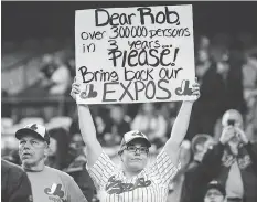  ?? DARIO AYALA / POSTMEDIA NEWS FILES ?? A fan holds a sign asking to bring back the Montreal Expos before a 2016 Blue Jays exhibition game in Montreal.