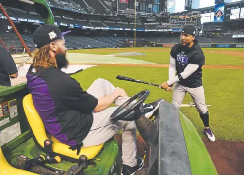  ?? Andy Cross, The Denver Post ?? Rockies leadoff hitter and center fielder Charlie Blackmon, left, and right fielder Carlos Gonzalez talk about hitting Tuesday before batting practice at Chase Field in Phoenix. Blackmon is the reigning National League batting champion. Gonzalez won...