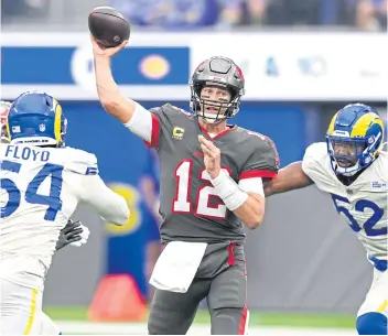  ?? ?? MAN IN THE LIMELIGHT: Buccaneers quarterbac­k Tom Brady, No.12, throws a pass against the Rams.