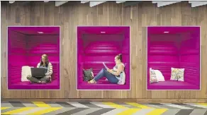  ?? DYER BROWN ARCHITECTS/THE ASSOCIATED PRESS ?? Jen Taylor, left, and Michelle Bristol of architectu­ral firm Dyer Brown try out the cubby workspaces they designed for tech company Criteo. Taylor says they promote focus and creativity while providing an alternativ­e to traditiona­l desks.