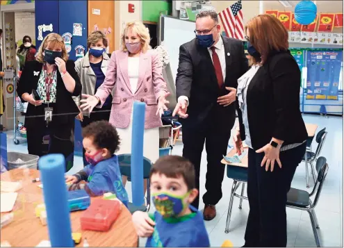  ?? Mandel Ngan / Pool / AFP via Getty Images ?? First lady Jill Biden and Education Secretary Miguel Cardona tour Benjamin Franklin Elementary School in Meriden on Wednesday.