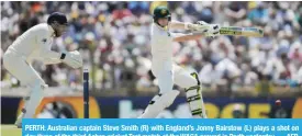  ??  ?? PERTH: Australian captain Steve Smith (R) with England’s Jonny Bairstow (L) plays a shot on day three of the third Ashes cricket Test match at the WACA ground in Perth yesterday. — AFP