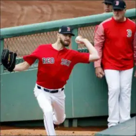  ?? ELISE AMENDOLA — THE ASSOCIATED PRESS ?? Boston’s Chris Sale throws in the bullpen during a workout at Fenway Park Wednesday.