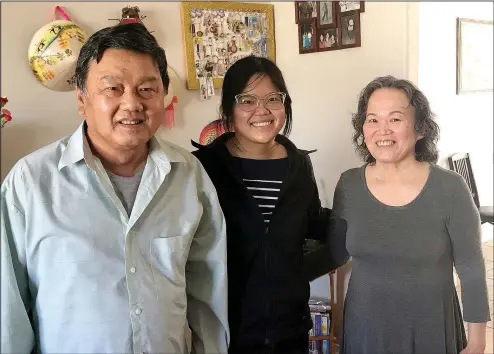  ??  ?? Family historian Mai Le (center) is looking back at her family’s history with her parents Huong Pham and Thinh Le. (NWA Democrat-Gazette/Janelle Jessen)