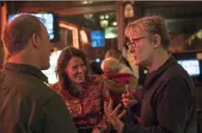  ?? Stephanie Strasburg/Post-Gazette ?? From left, Bob Baumbach and Jess Johnson, both of Deutschtow­n, talk with Diana Nelson Jones on Friday at Max's Allegheny Tavern in Deutschtow­n. Since getting new hearing aids, Jones is excited that she can again meet with friends in noisy bars and restaurant­s, among many other settings that she had had been avoiding because of her hearing loss.