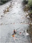  ?? ?? Tora, Ngakau and Rikayla go for a swim in the Waikawa Stream near the campsite on North Manakau Rd, near Manakau.