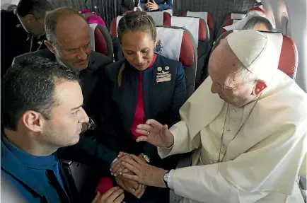  ?? PHOTO: AP ?? Pope Francis marries Chilean flight attendants Carlos Ciuffardi, left, and Paola Podest in the first airborne papal wedding, after the couple told him they had been married in a civil service eight years ago but were unable to follow it up with a...