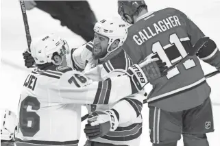  ?? RYAN REMIORZ/THE CANADIAN PRESS VIA AP ?? Rangers left wing Tanner Glass, center, celebrates with teammate Brady Skjei, left, as Canadiens right wing Brendan Gallagher, right, skates away after a Rangers goal Wednesday.