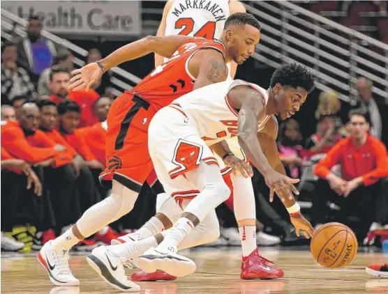  ?? | MATTMARTON/ AP ?? Justin Holiday, battling for a loose ball with Raptors guard Norman Powell, has emerged as a team leader as well as the Bulls’ go- to scorer.