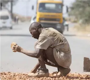  ?? — Picture: Innocent Makawa ?? A man voluntaril­y repairs a pothole in Ardbennie, Harare, last week.