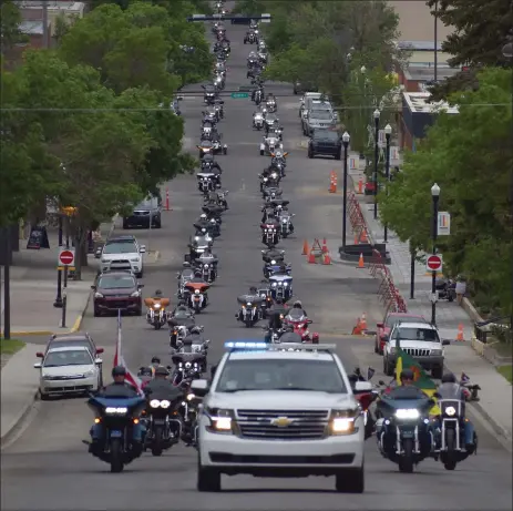  ?? Photos by Matthew Liebenberg/Prairie Post ?? A long line of motorcycle­s travel along Central Avenue North in Swift Current during the Ride for Dad parade through city streets, June 11.